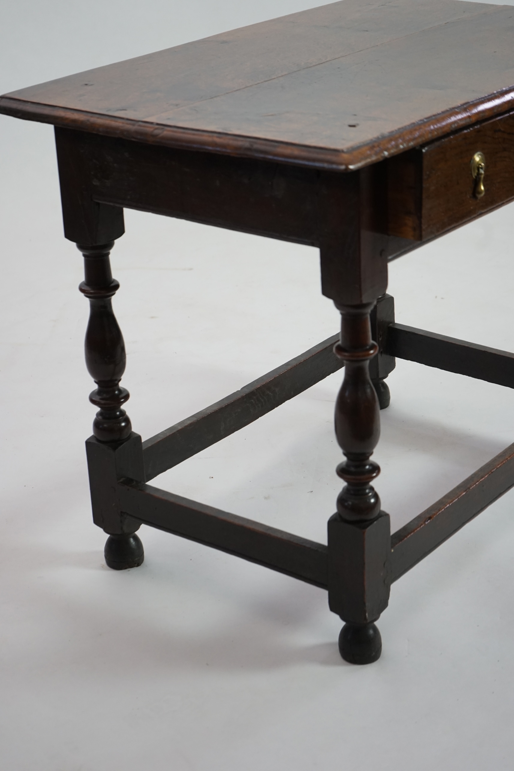 An early 18th century and later oak side table